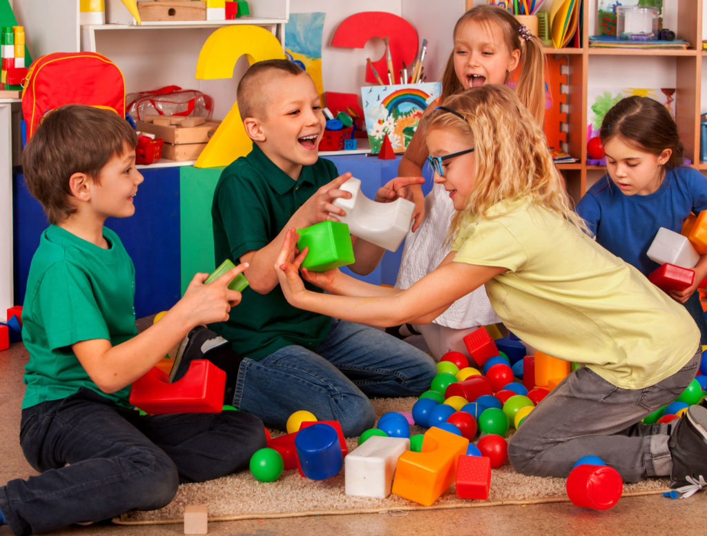 Group boys and girls playing toy on floor